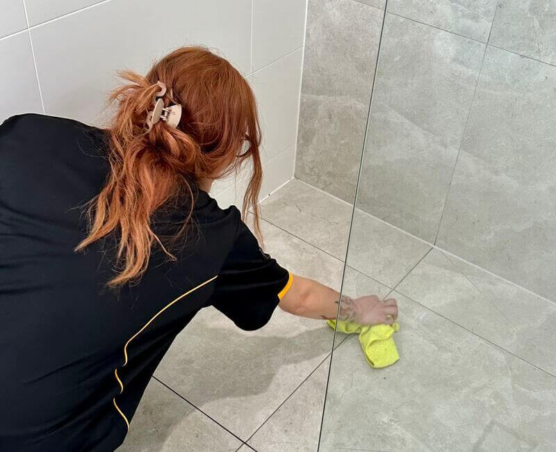 Brisbane-professional-house-cleaner-wiping-shower-floor Maid2Match House Cleaning Brisbane professional cleaner wiping shower floor