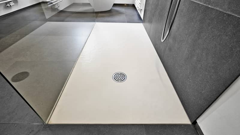 Corian floor and drain from modern shower in luxury bathroom