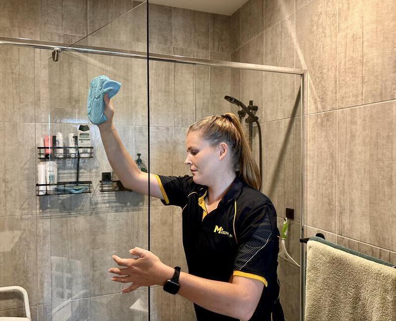 brisbane-house-cleaner-cleaning-shower-glass Maid2Match Brisbane professional cleaner Courtney cleaning shower glass