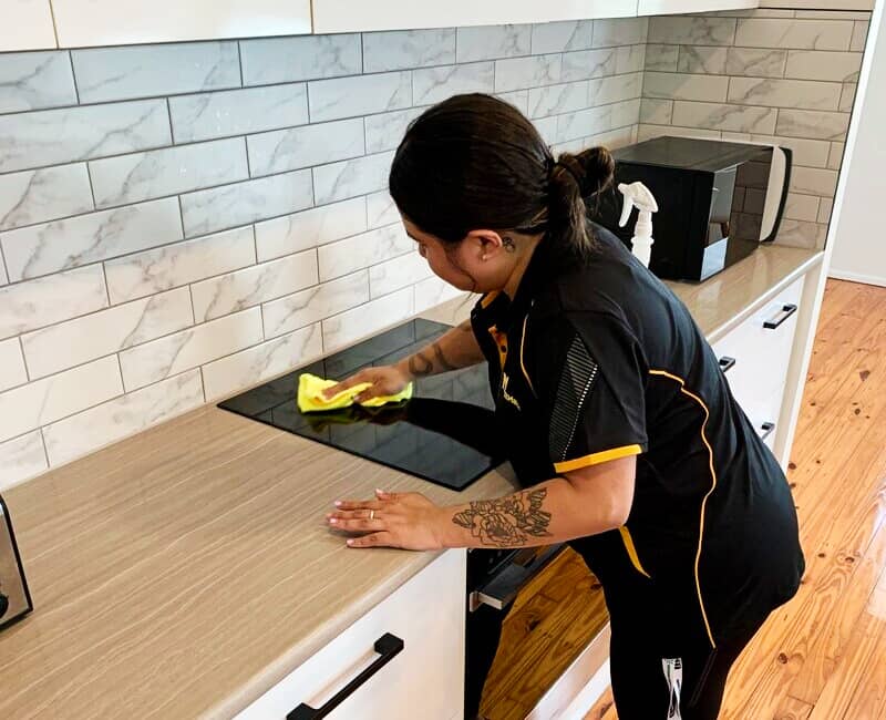 Maid2Match experienced cleaner Shania cleaning glass cooktop with microfibre cloth