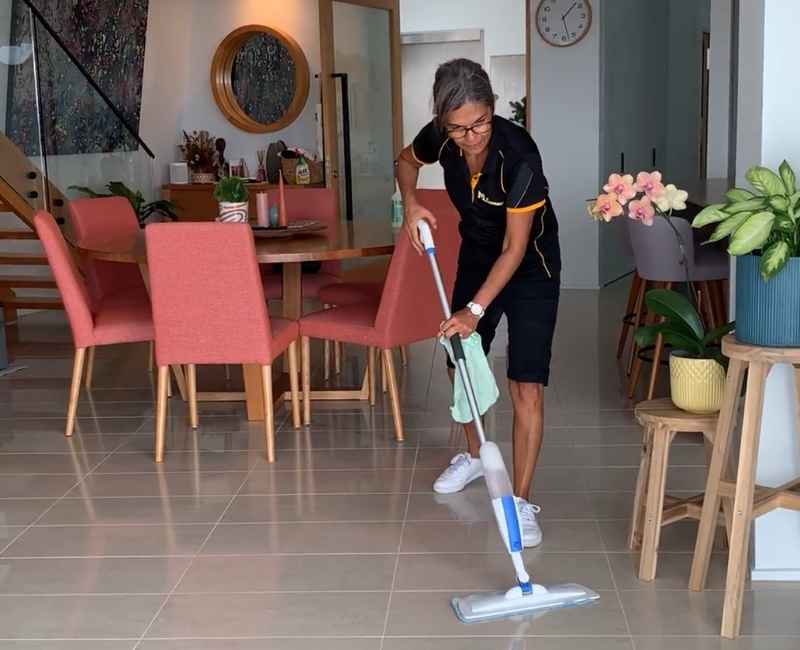 professional cleaner using blue and white flat mop to clean floor