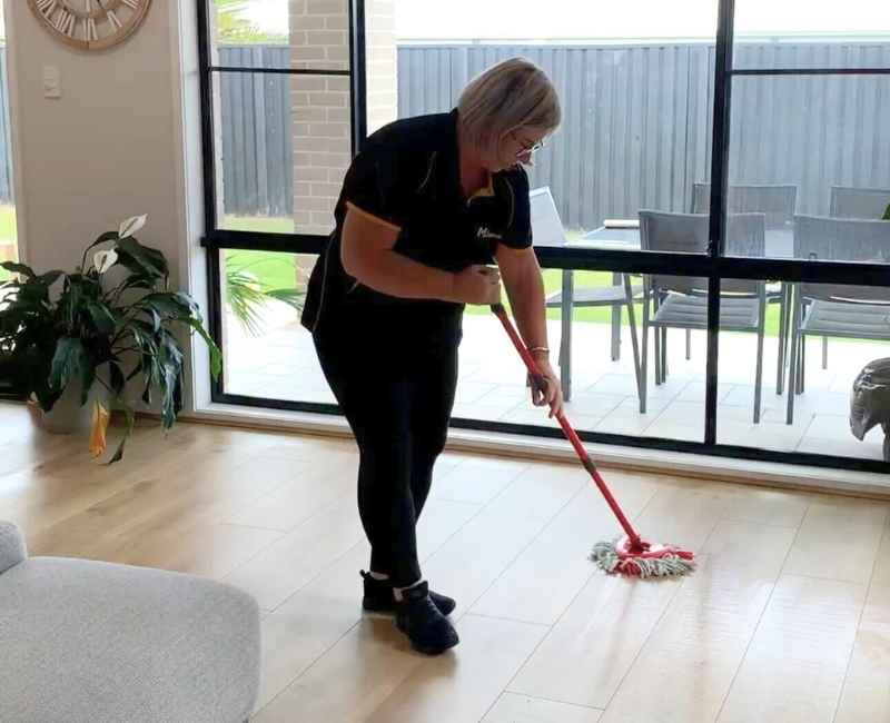professional cleaner using spin mop to clean floors