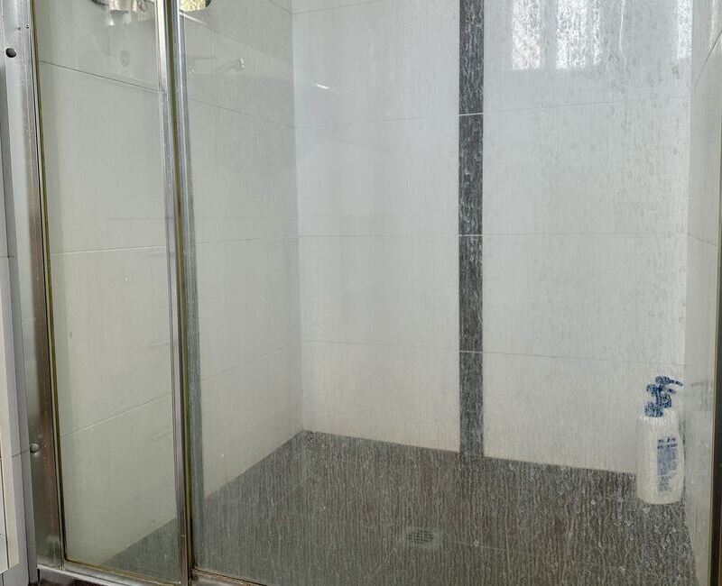 hard-water-stains-on-shower-glass glass shower door with hard water stains