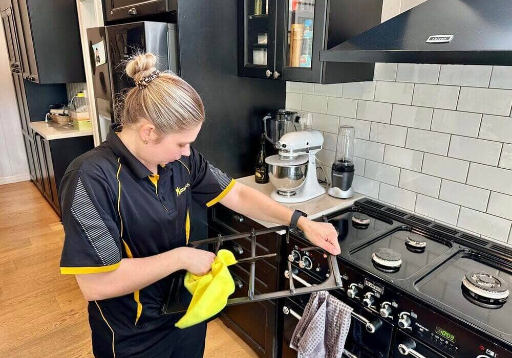 Maid2Match professional cleaner Kate-Lyn cleaning stove top grates