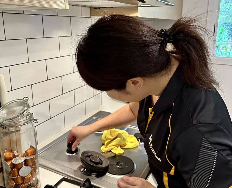 Shinobu taking the parts of the gas stovetop off to clean