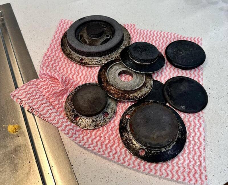 Stovetop burners and other parts removed for cleaning