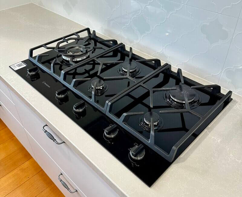 Clean stovetop grates on a stovetop