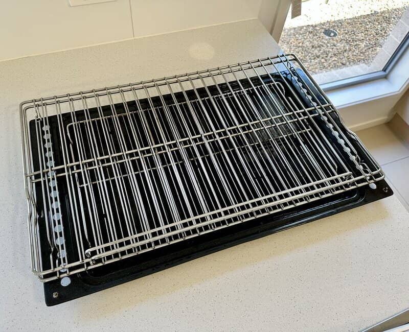 clean oven racks neatly arranged on a benchtop