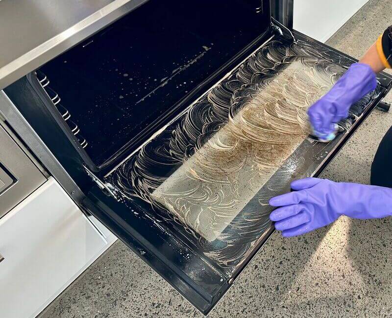 Brisbane house cleaner cleaning inside the oven glass