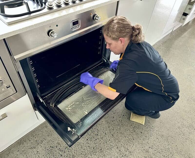 professional cleaner Nicola cleaning glass oven door