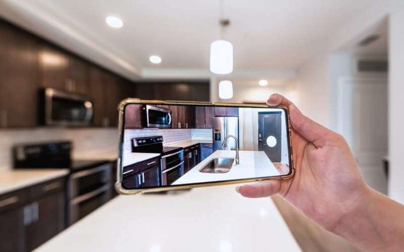 hand taking a photo of kitchen interior
