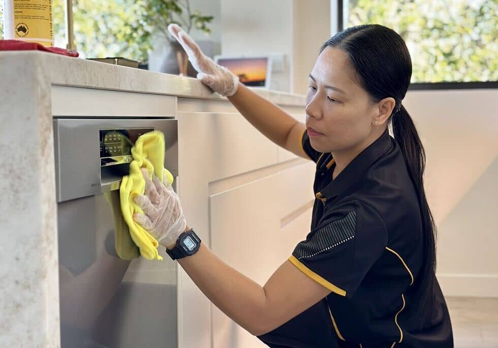 Maid2Match-Paige-cleaning-the-exterior-of-a-dishwasher Maid2Match Paige cleaning the exterior of a dishwasher