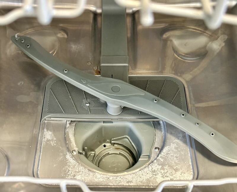 drain part of the dishwasher covered in grime and limescale