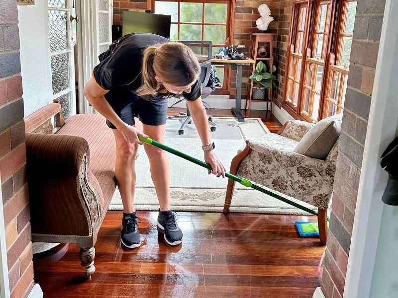 Maid2Match professional cleaner mopping wooden floor