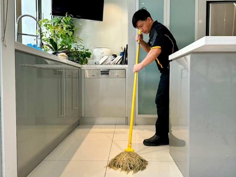 Maid2Match cleaner mopping tiled floor