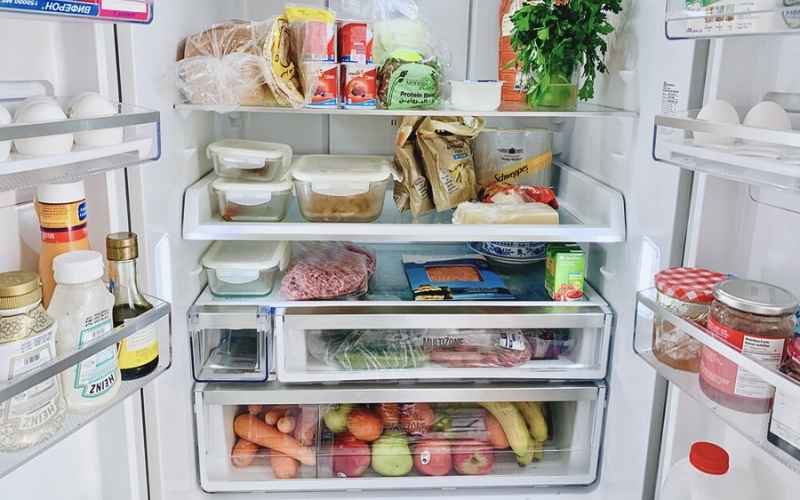 clean open fridge with groceries