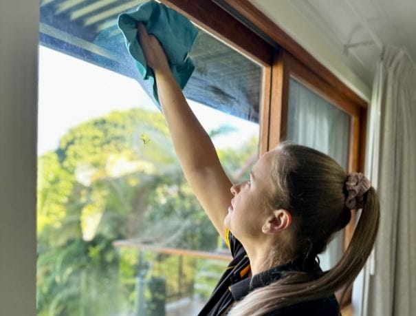 stevie-cleaning-window Maid2Match bond cleaner wiping glass window