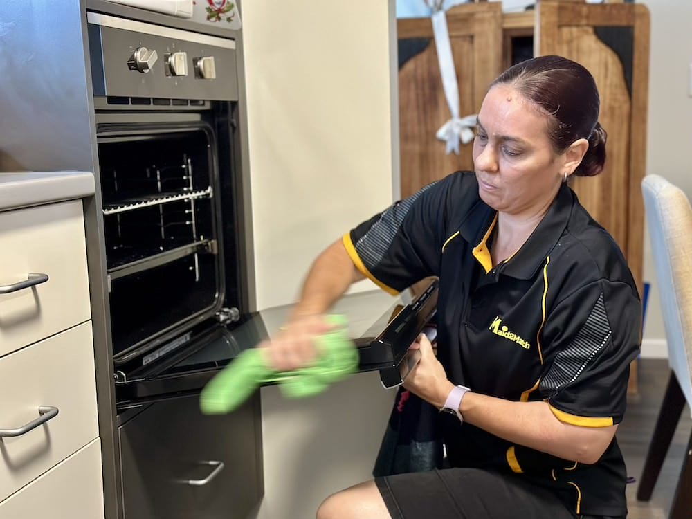 Logan-professional-NDIS-cleaner-Sharlene-cleaning-oven Sharlene cleaning an NDIS customer's oven