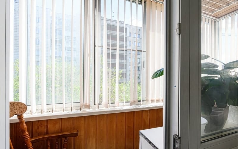 bright balcony with white vertical blinds