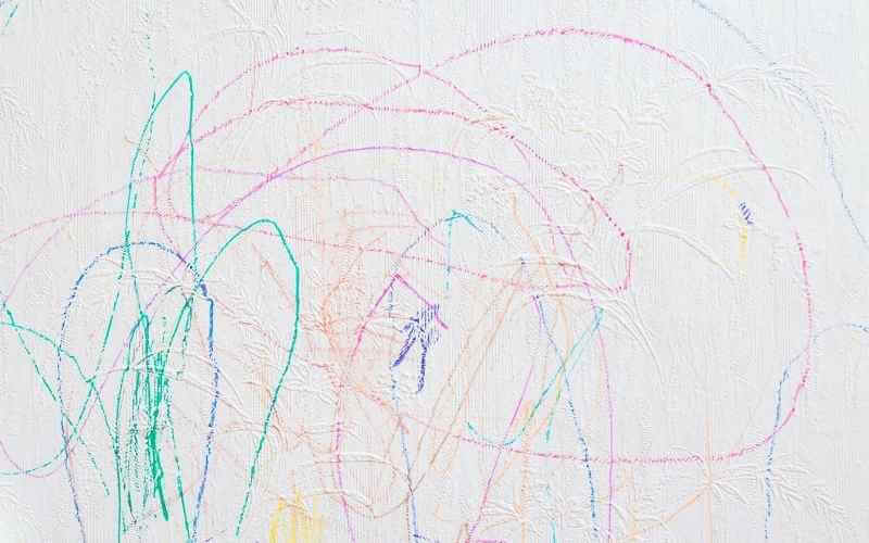colorful permanent marker stains on white wall