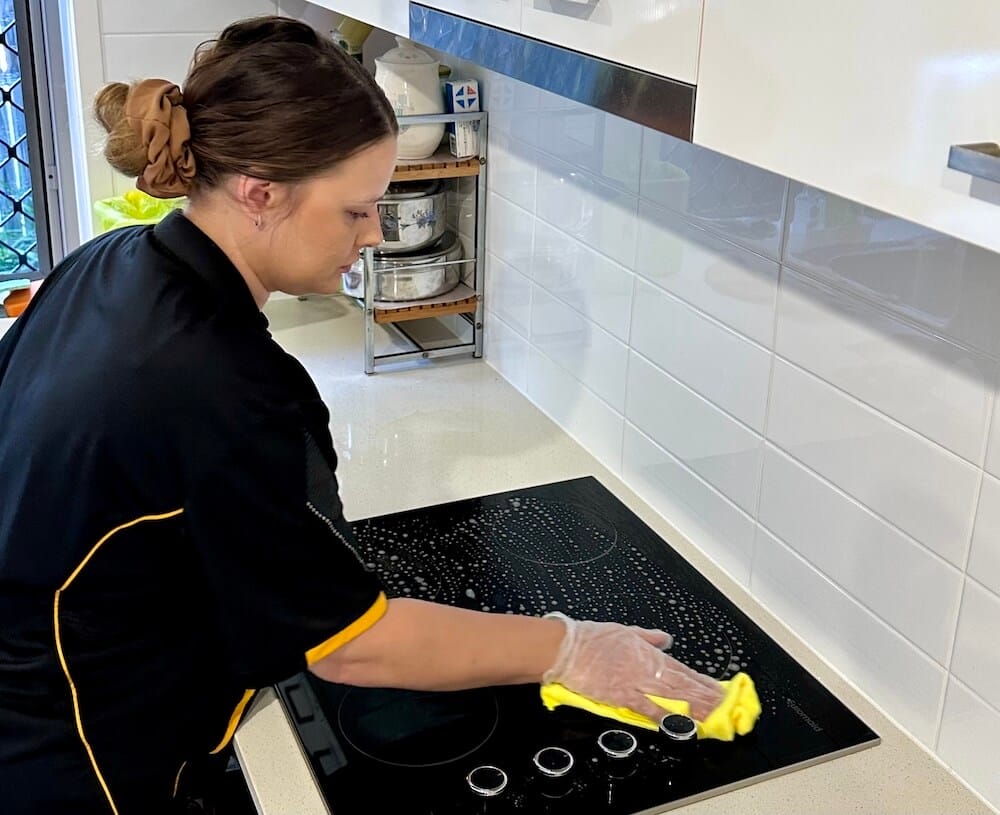 professional-NDIS-cleaner-Logan Professional NDIS cleaner in Logan, Alison, cleaning a stovetop