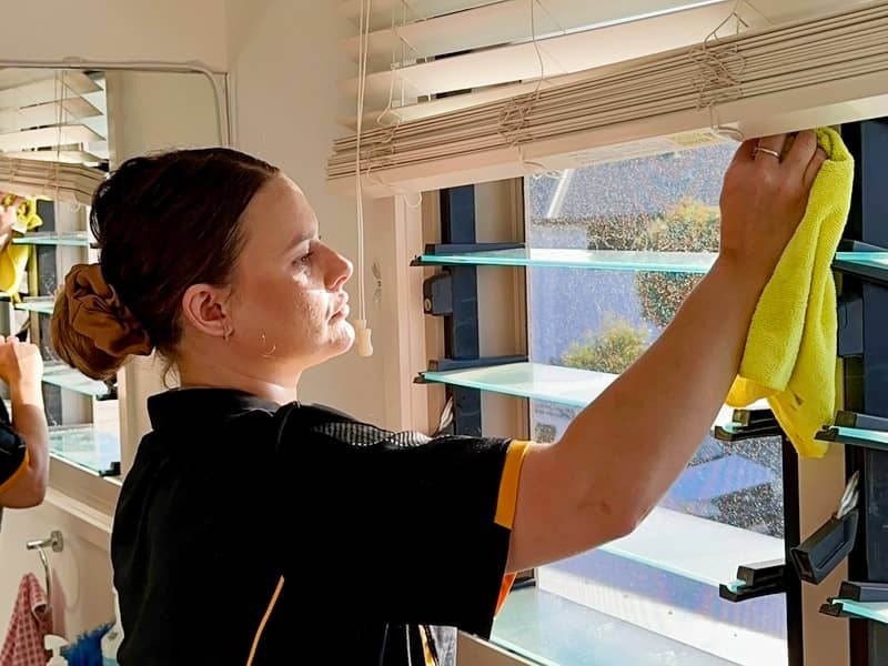 professional cleaner Alison cleaning the frame of Louvre windows