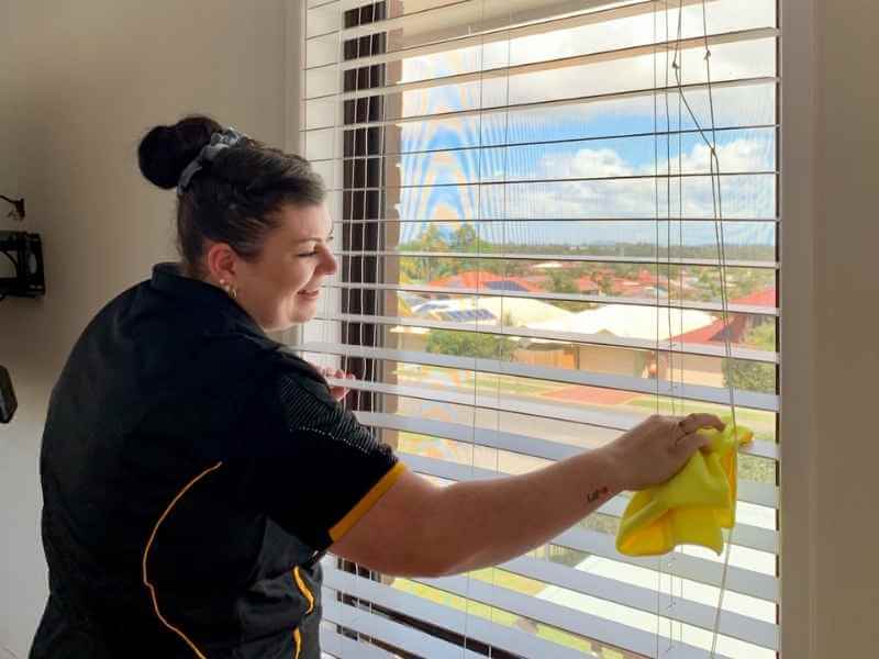 Maid2Match professional cleaner wiping blinds
