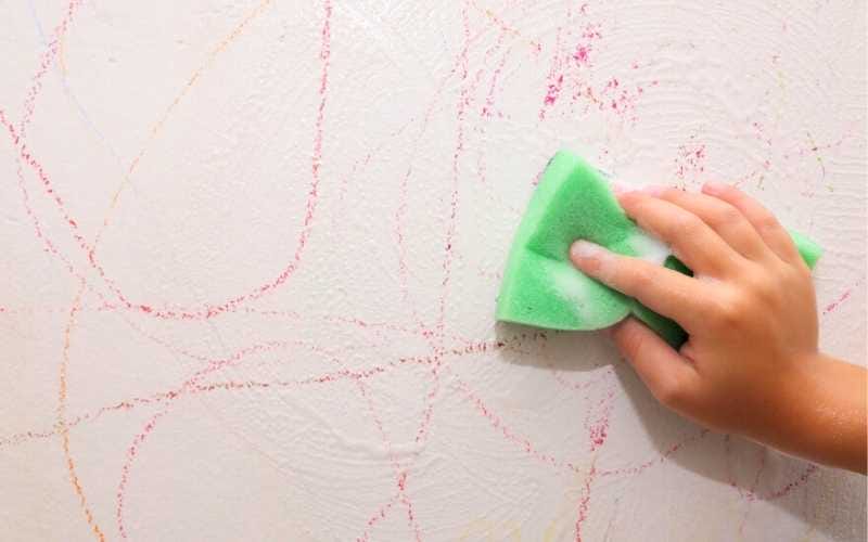 removing crayon marks with sponge soaked in dish soap