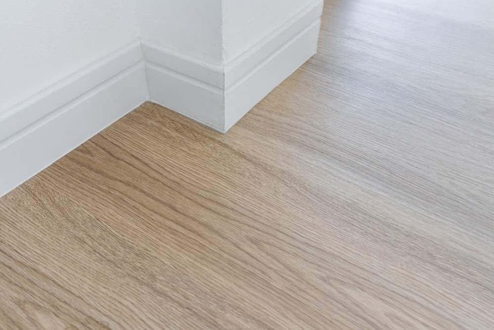 Vinyl panel flooring near white wall