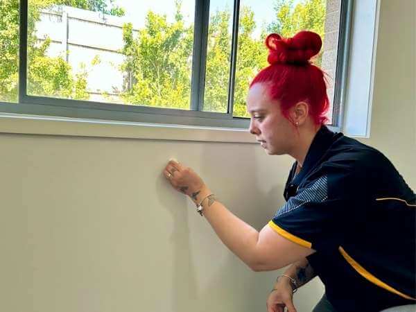 professional house cleaner cleaning wall with baby wipes