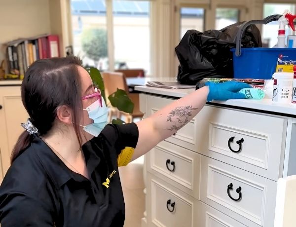 Maid2Match-Adelaide-NDIS-cleaner-Susie Maid2Match Adelaide NDIS professional cleaner, Susie - cleaning up cabinet items