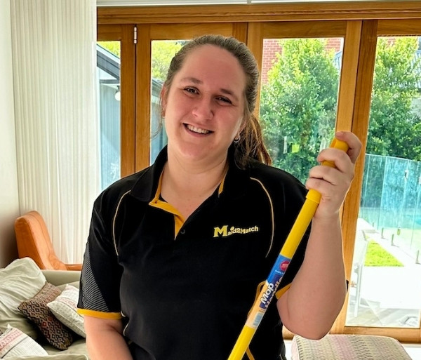Maid2Match-NDIS-Adelaide-cleaner-Brooke Maid2Match NDIS Adelaide professional cleaner, Brooke F. holding a mop handle