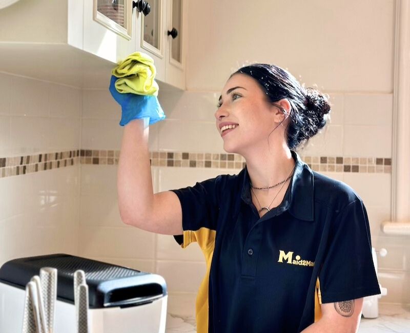 Maid2Match house cleaner Adelaide cleaning cabinets Maid2Match house cleaner in Adelaide cleaning cabinet exteriors with microfibre cloth