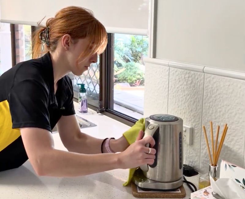 house cleaner Jacinta cleaning the exterior of an electric kettle