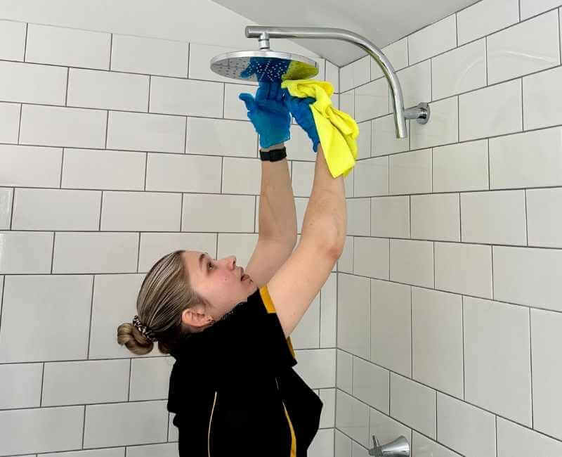 Maid2Match Brisbane Professional Cleaner, Kate-Lyn - cleaning shower head