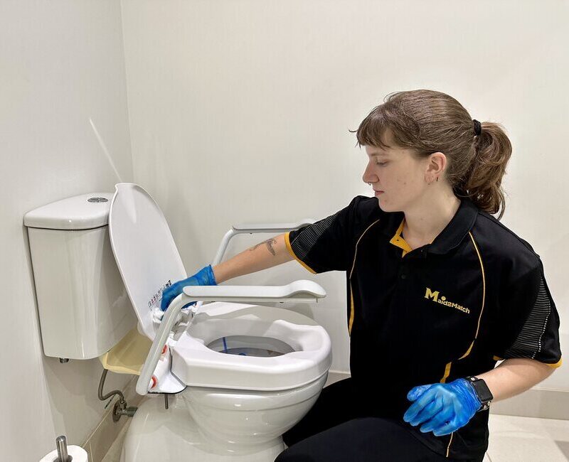 Kayleigh cleaning a toilet