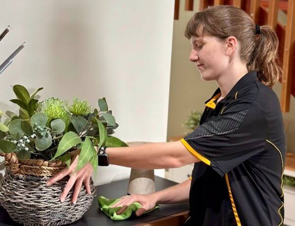 Kayleigh-cleaning-around-living-area Maid2Match Brisbane professional house cleaner Kayleigh cleaning around living area