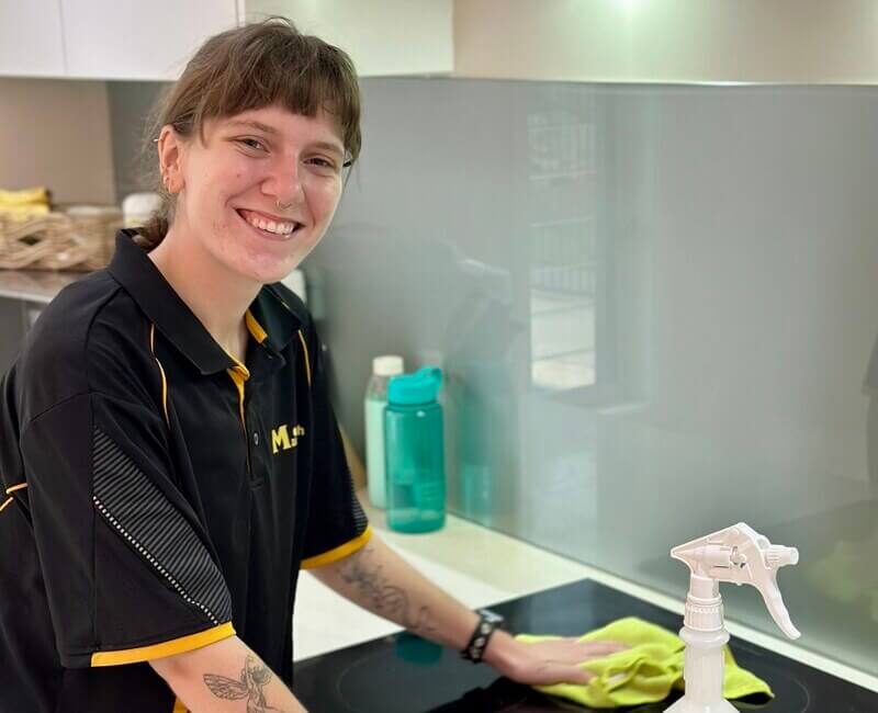 Maid2Match professional house cleaner Kayleigh cleaning stovetop