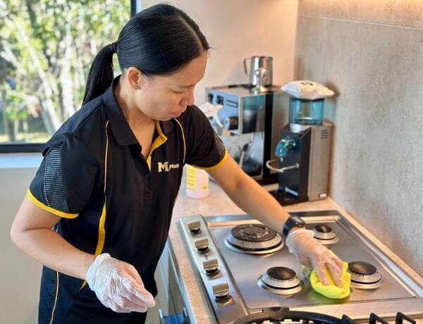 Paige-cleaning-stovetop Maid2Match Brisbane and Ipswich professional house cleaner, Paige, cleaning a stovetop