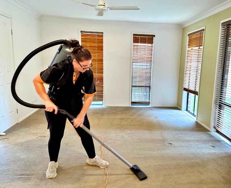 Maid2Match bond cleaner Jarna vacuuming the carpet in a vacated room