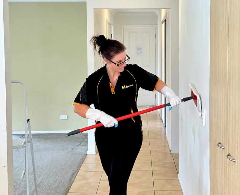 Maid2Match bond cleaner Jarna washing the walls of a vacated house
