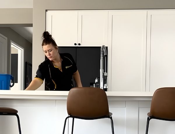 Maid2Match Brisbane professional cleaner Jacynta cleaning a benchtop