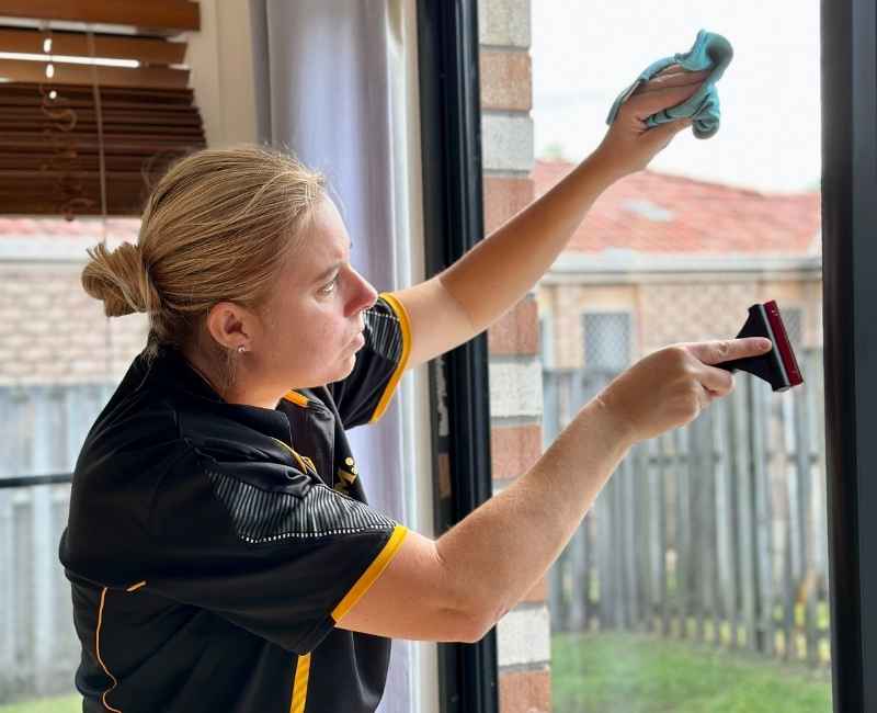 Maid2Match professional house cleaner and bond cleaner cleaning window interior