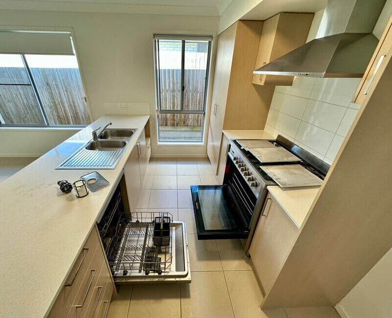 Recently bond cleaned kitchen with dishwasher, oven, and rangehood