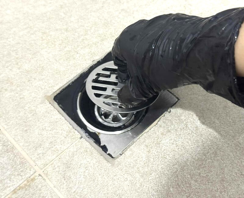 putting back shower drain components after cleaning