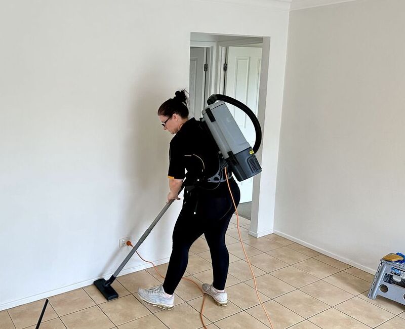 professional cleaner Renee vacuuming floors, bond cleaning