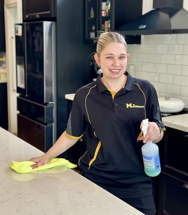 Maid2Match DVA Cleaning services - DVA professional cleaner Kate-lyn smiling while cleaning