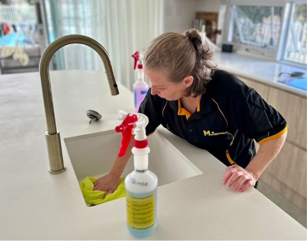 Maid2Match DVA Cleaning - professional cleaner Nicole cleaning a kitchen sink