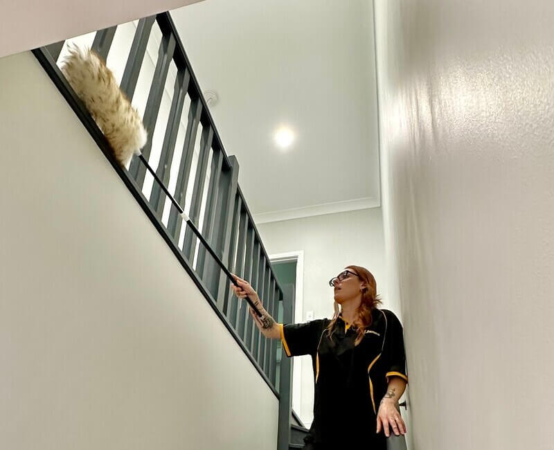 Maid2Match-NDIS-cleaner-Maria-dusting-stairs-railing Maid2Match NDIS cleaner Maria dusting the stairs railing