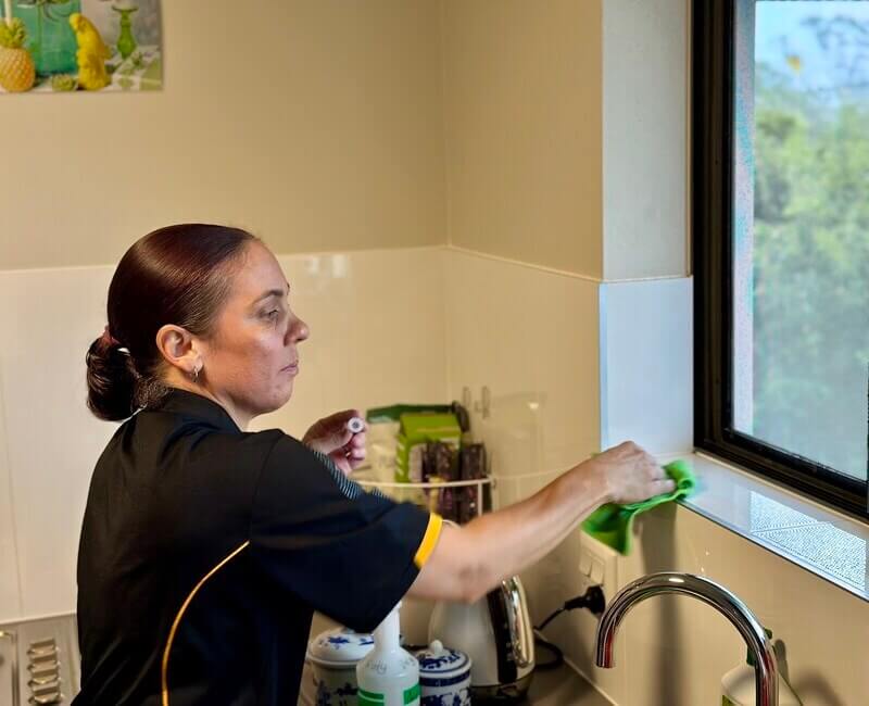 professional-NDIS-cleaner-Sharlene-cleans-around-kitchen Maid2Match NDIS cleaner Sharlene cleaning around the kitchen